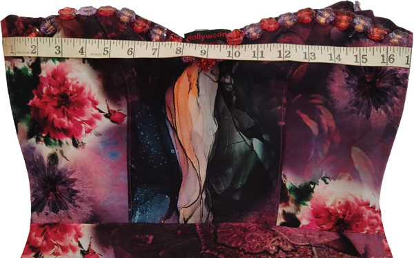 Young girl wearing a colorful off-shoulder dress on a white background