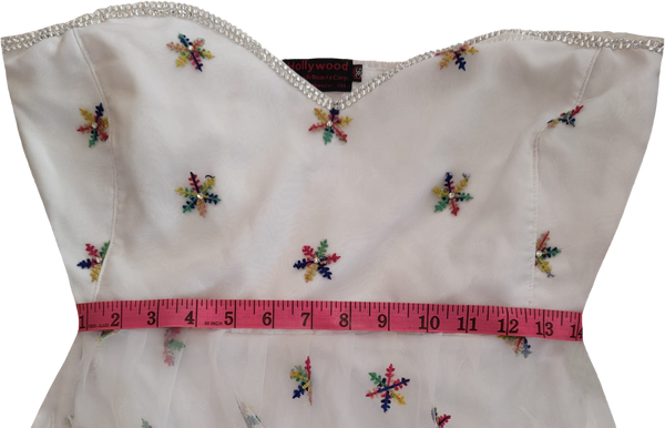 White off-shoulder dress with colorful arm sleeves white beaded floral on a white background