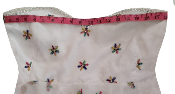 White off-shoulder dress with colorful arm sleeves white beaded floral on a white background