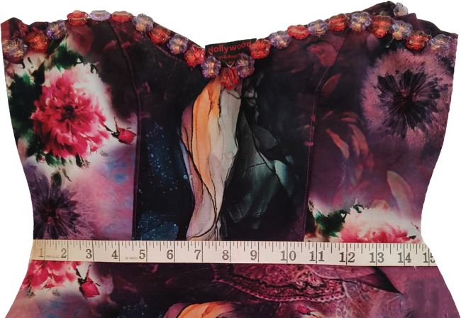 Young girl wearing a colorful off-shoulder dress on a white background