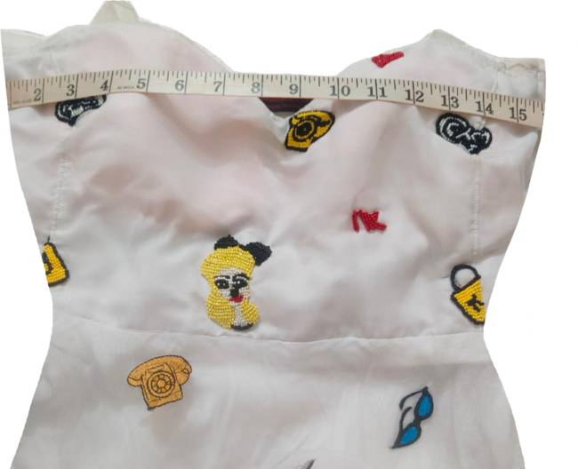 A Colorful Hand-Stitched Needle Work Beaded Design On White Back Ground