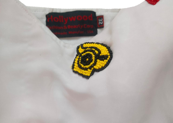 A Colorful Hand-Stitched Needle Work Beaded Design On White Back Ground