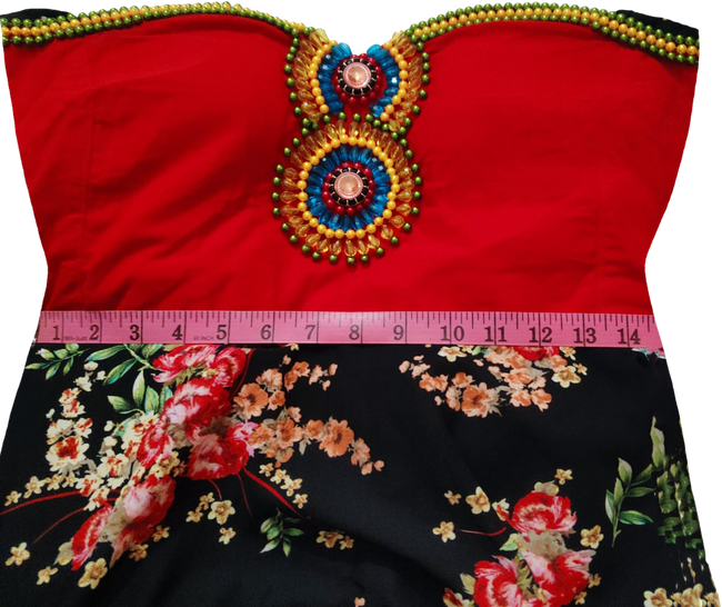 Off Shoulder Floral Design Handmade Decorative Colorful Beads,  Stones And Matching Lace  on a red fabric background,