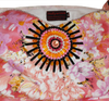 A woman wearing an off-shoulder pink gown Handmade beaded decorative with white patterns and beaded details.